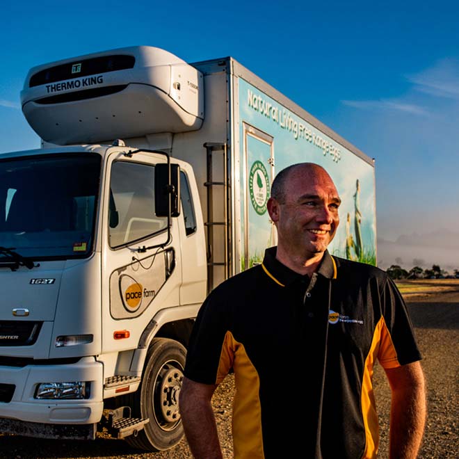 Truck driver standing with his delivery truck